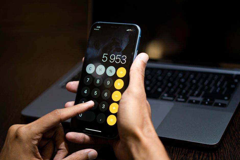 person using a digital calculator on a smartphone to check move-in costs