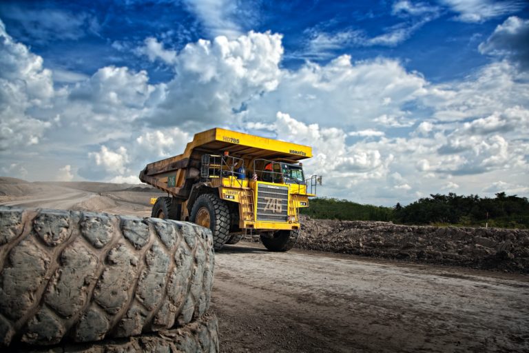 a yellow truck on a dirt road